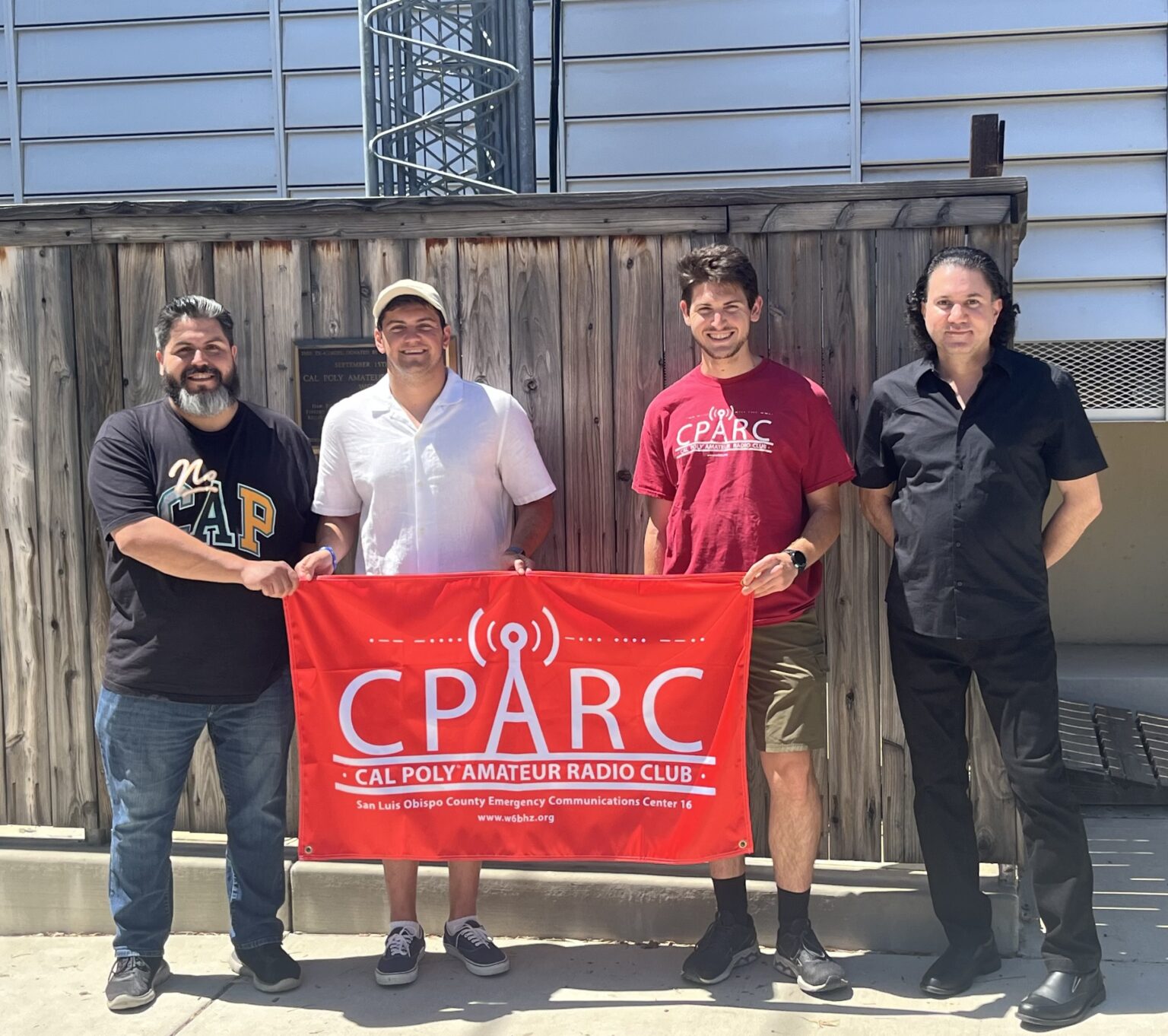 Group from the Cal Poly Amateur Radio Club (CPARC) holding their club banner